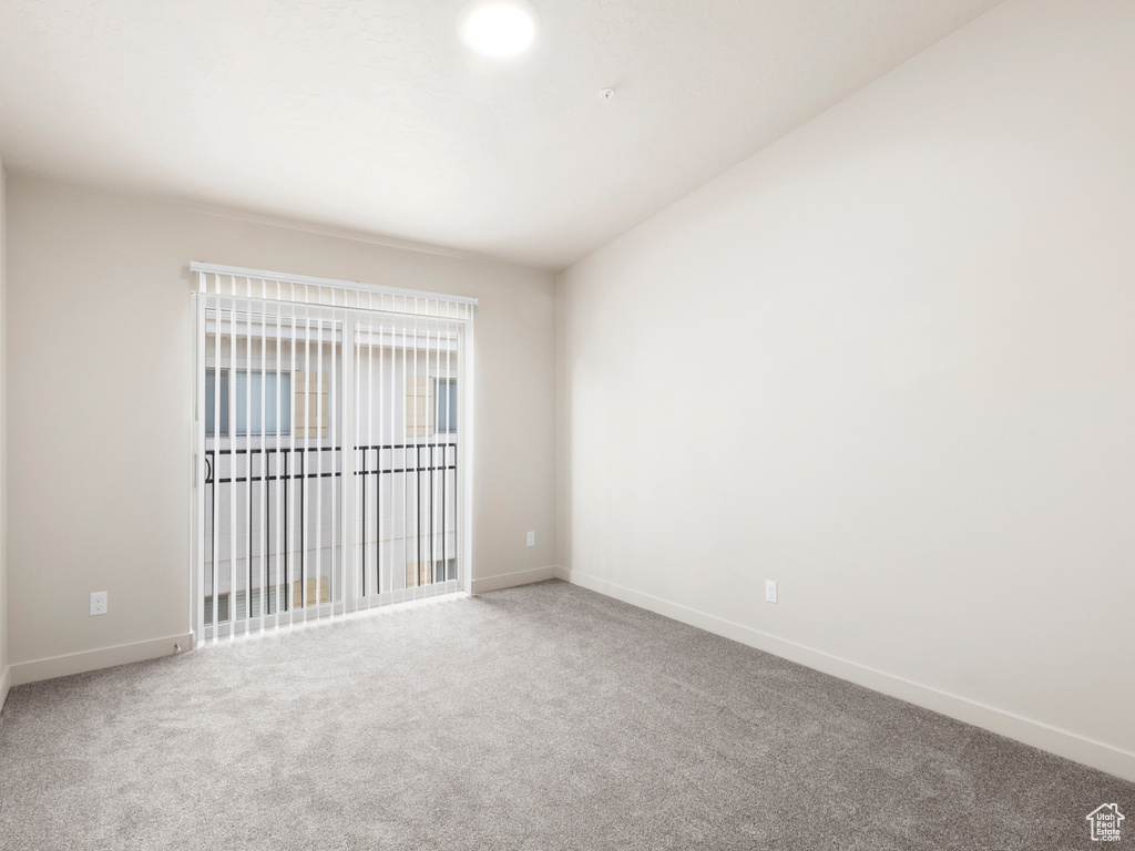 Carpeted empty room with baseboards