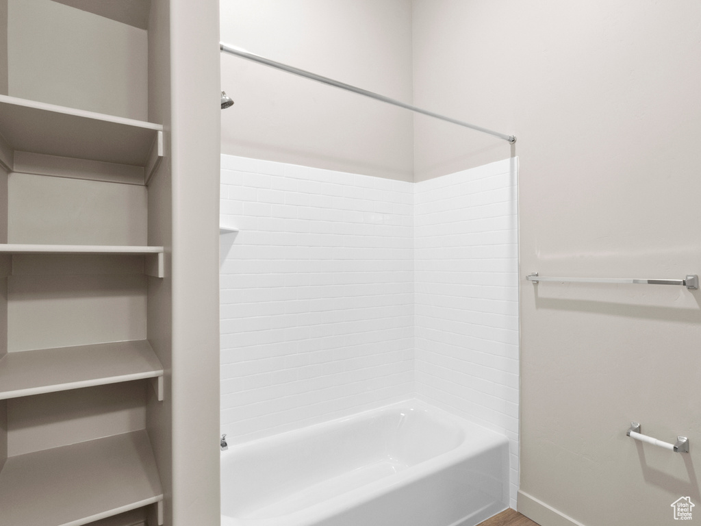 Full bathroom with  shower combination and baseboards