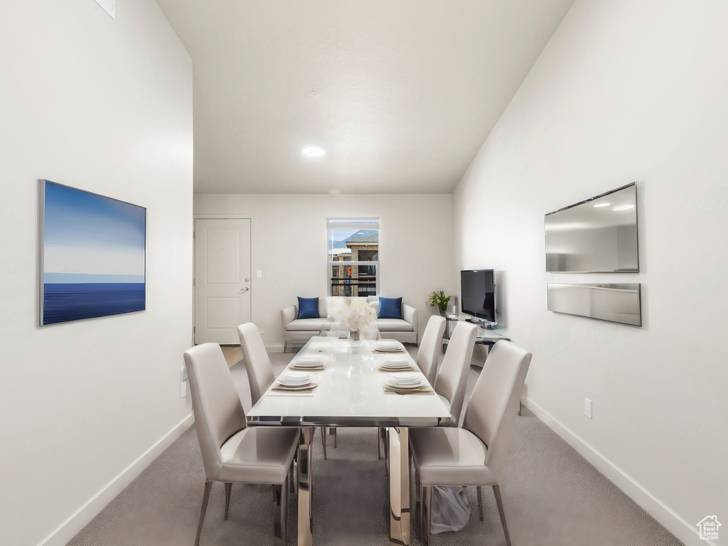Carpeted dining room with baseboards