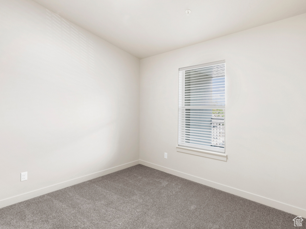 Unfurnished room with carpet floors and baseboards