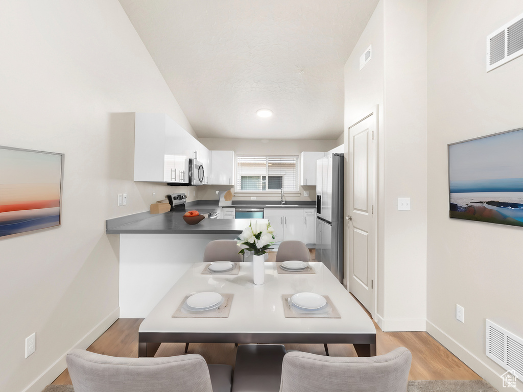 Dining space featuring light wood-type flooring and baseboards