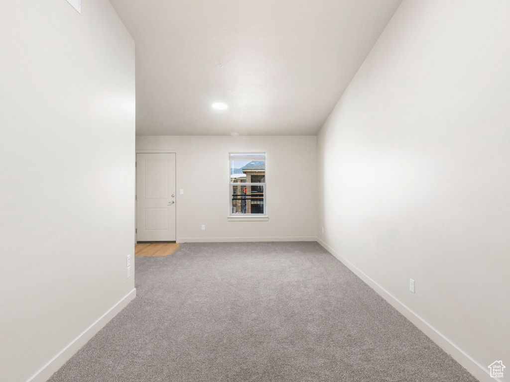 Spare room featuring light colored carpet and recessed lighting