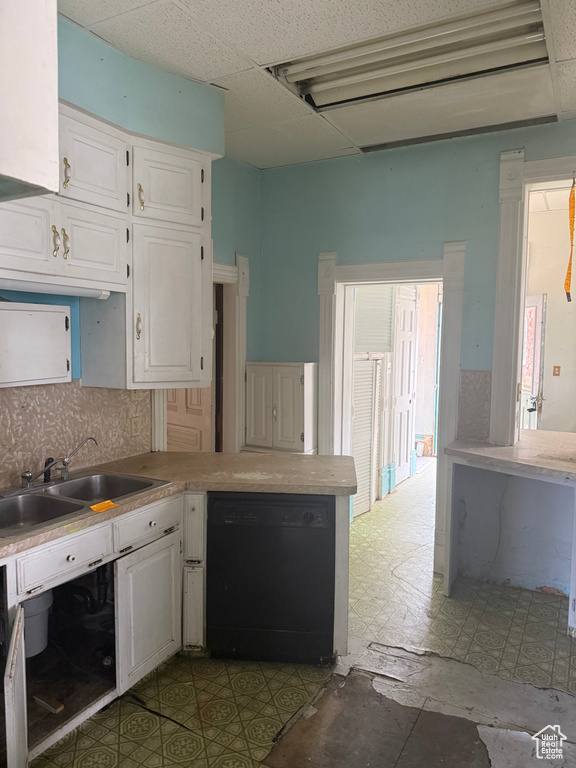 Kitchen featuring dishwasher, white cabinets, tile patterned floors, and light countertops