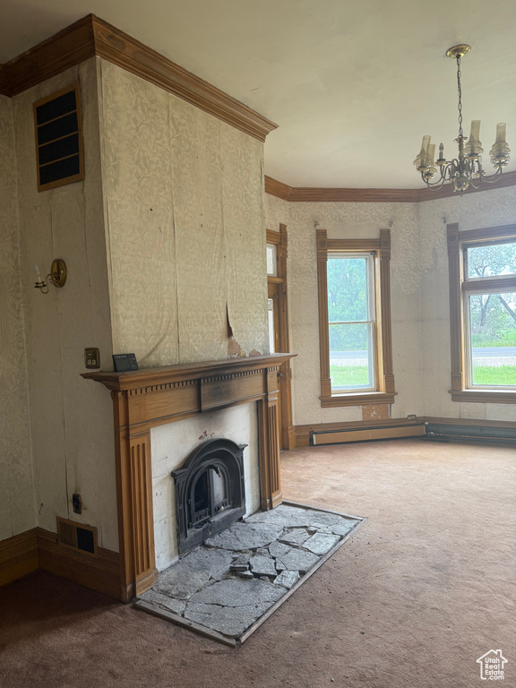 Unfurnished living room with carpet flooring, a chandelier, ornamental molding, and a fireplace