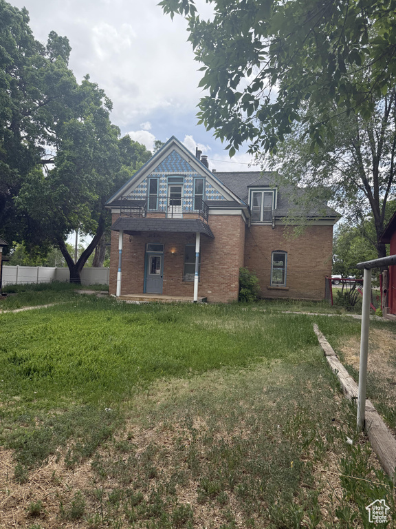 Rear view of property with brick siding and a chimney