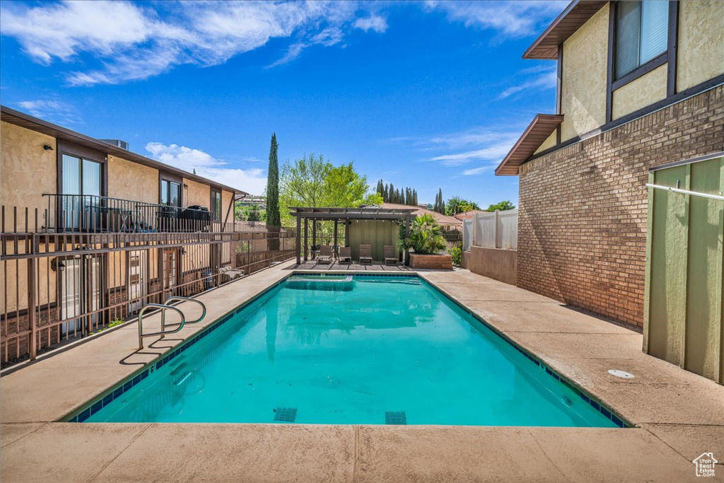 View of pool featuring a fenced backyard and a patio area