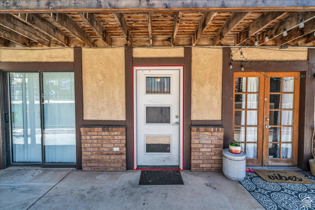 Property entrance with french doors and stucco siding