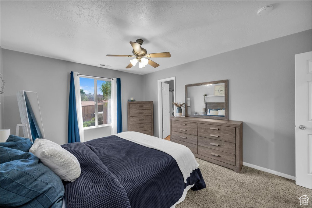Bedroom featuring light colored carpet and a ceiling fan