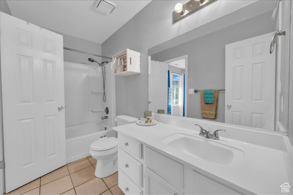 Bathroom with tile patterned floors, vanity, and shower / bathtub combination