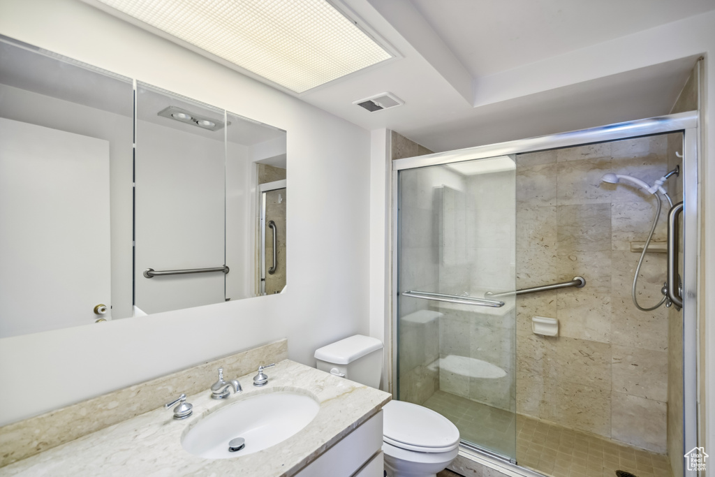 Bathroom with vanity and a shower stall