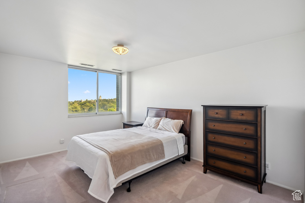 Bedroom featuring light colored carpet