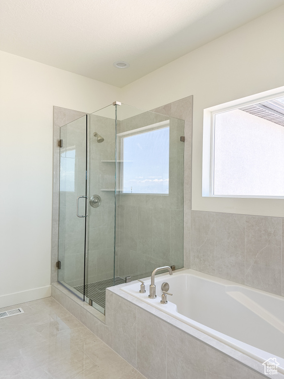 Bathroom featuring a garden tub and a stall shower