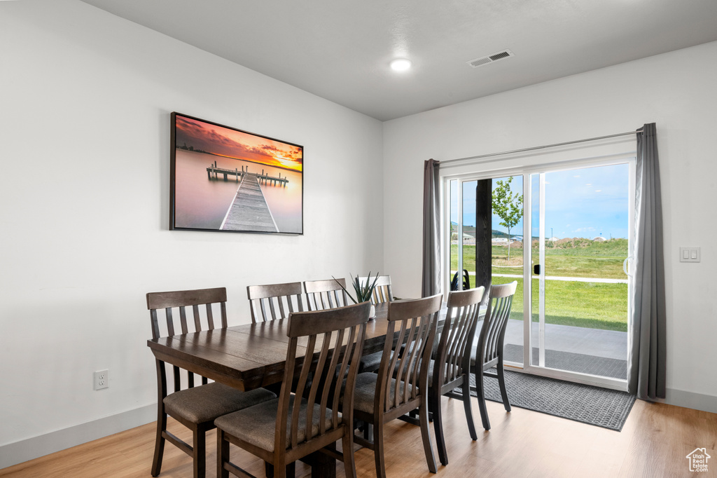 Dining area with baseboards and wood finished floors