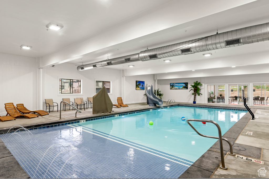 Indoor pool featuring a water slide