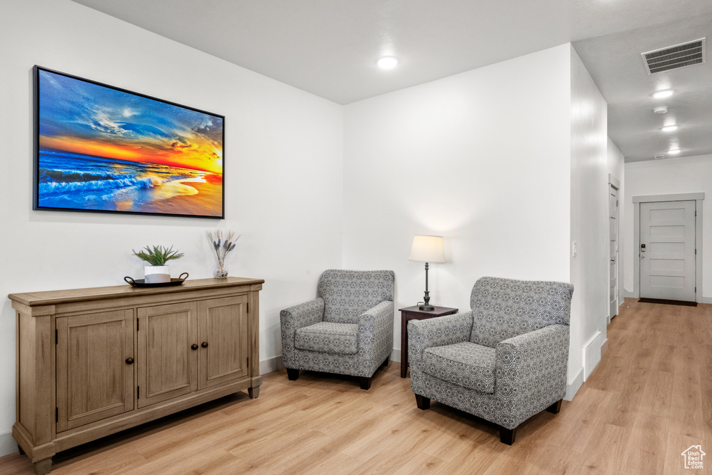 Living area featuring light wood-style floors and baseboards