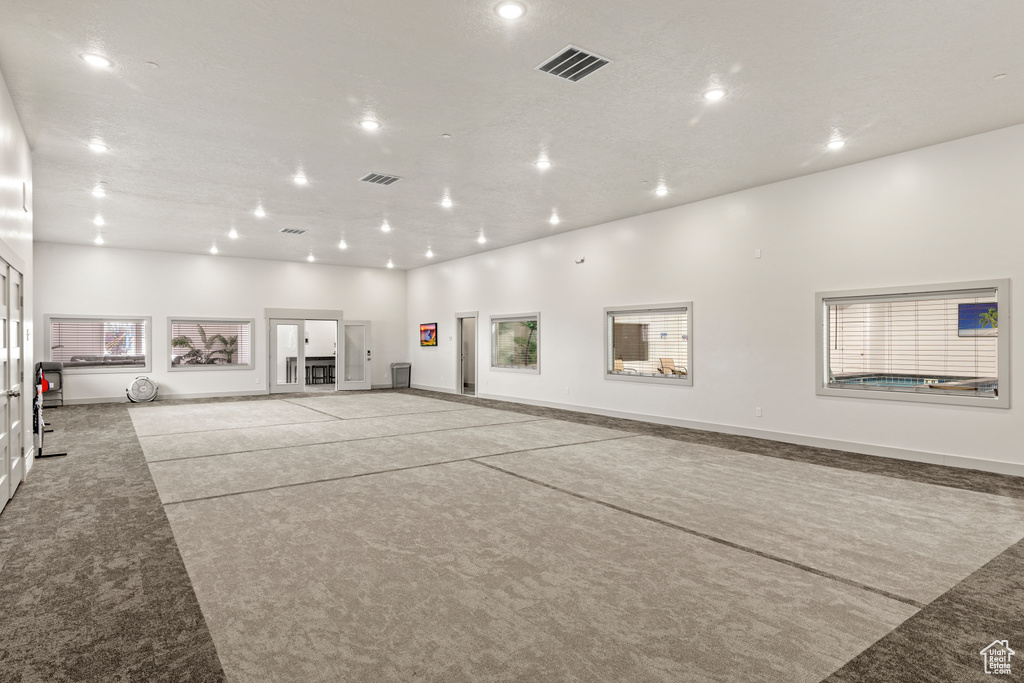 Interior space featuring light colored carpet, french doors, and recessed lighting