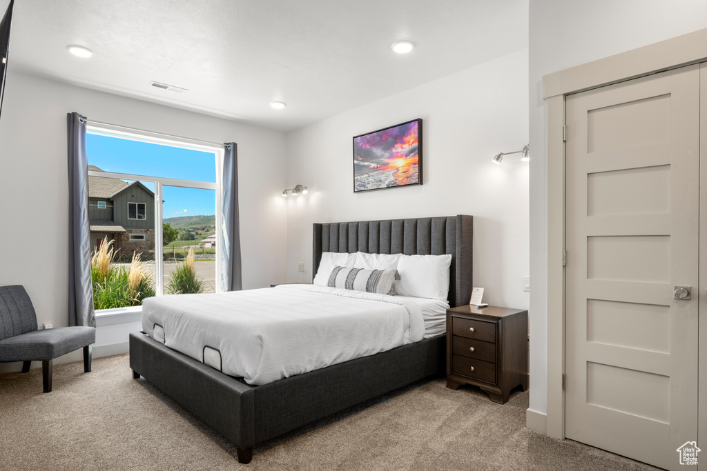 Bedroom featuring light colored carpet and recessed lighting