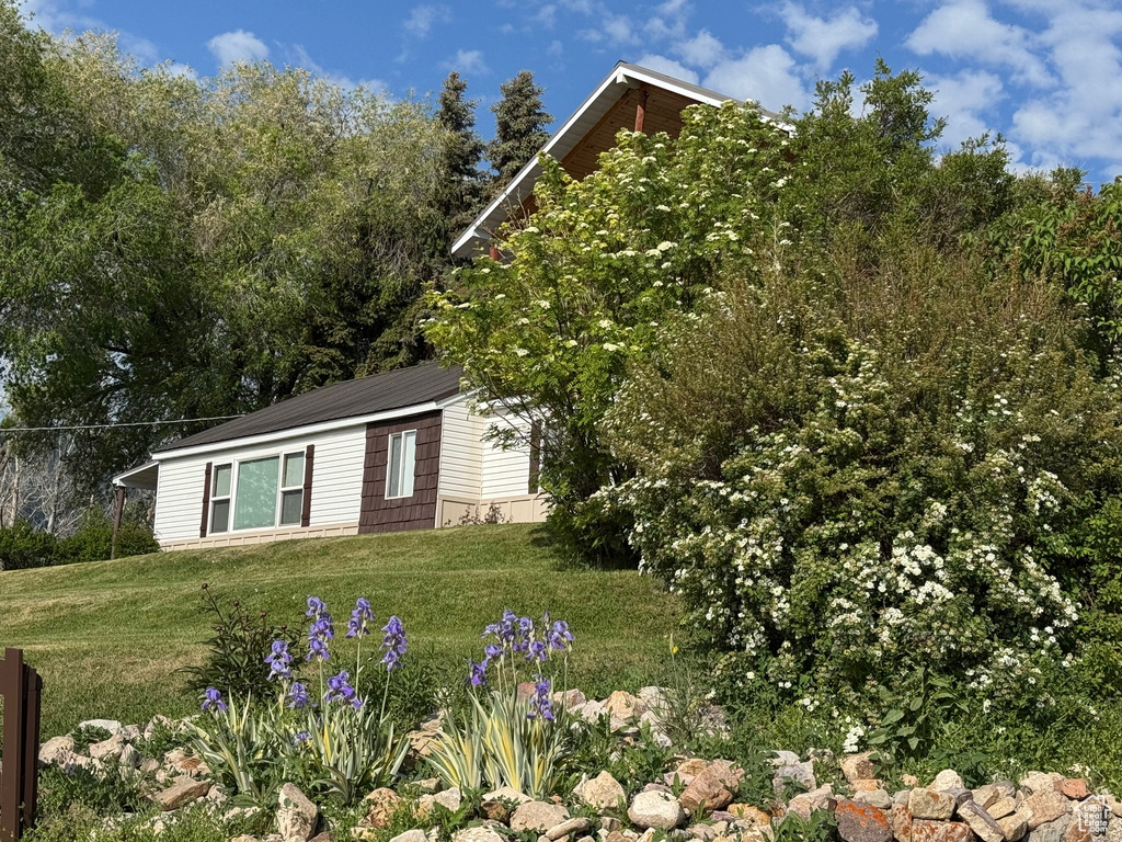View of side of home with a yard