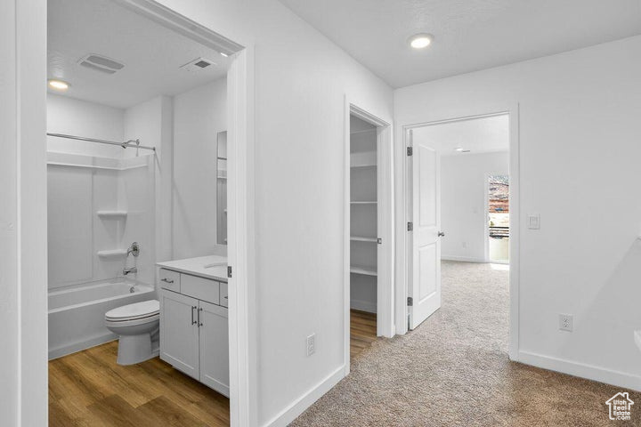 Full bathroom featuring vanity,  shower combination, and recessed lighting
