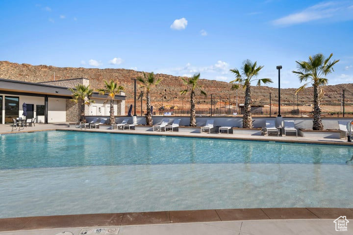 Community pool with a patio area and a mountain view