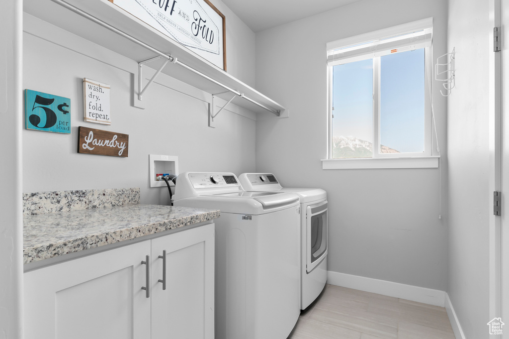Laundry room featuring baseboards and washer and clothes dryer