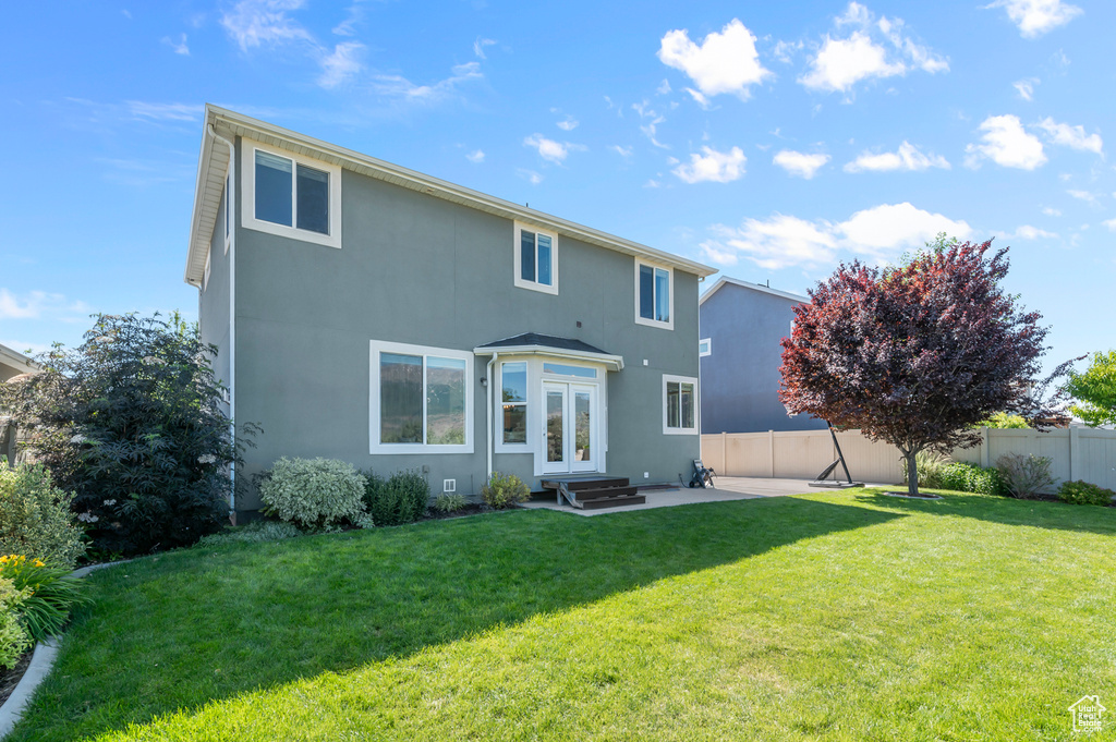Back of house featuring french doors, a patio, stucco siding, and entry steps