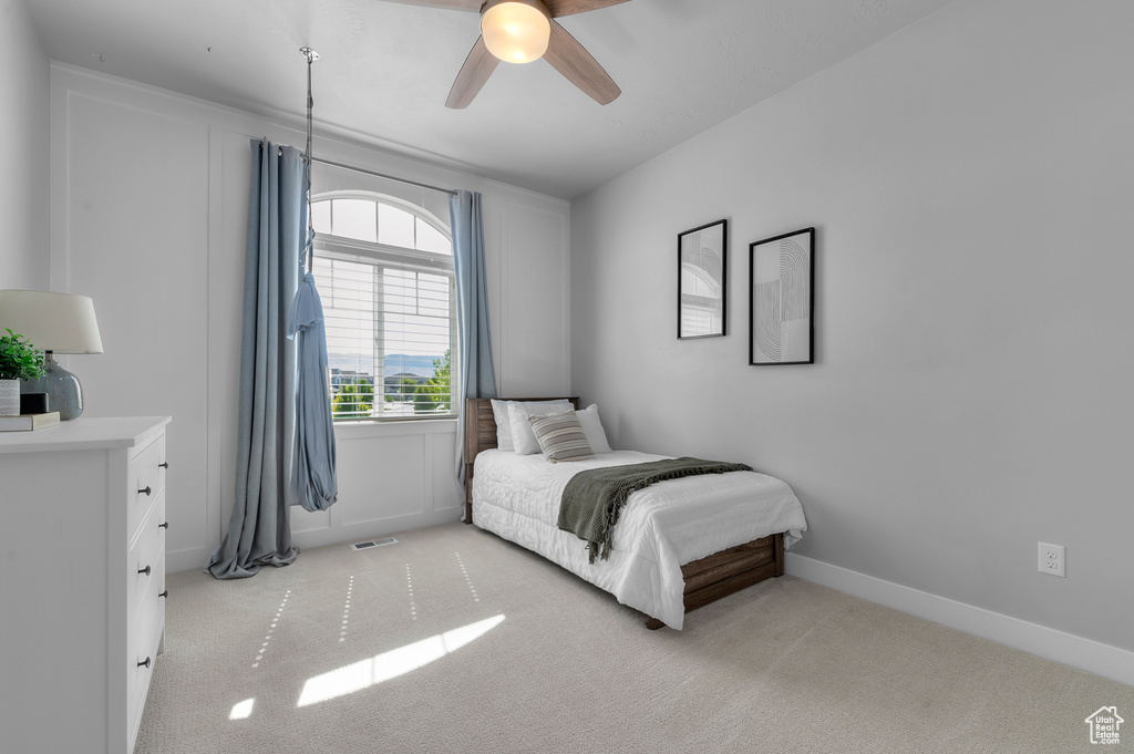 Bedroom featuring light carpet and a ceiling fan