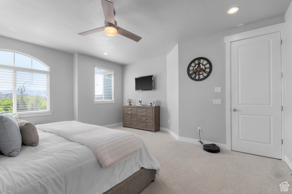 Carpeted bedroom featuring ceiling fan and recessed lighting