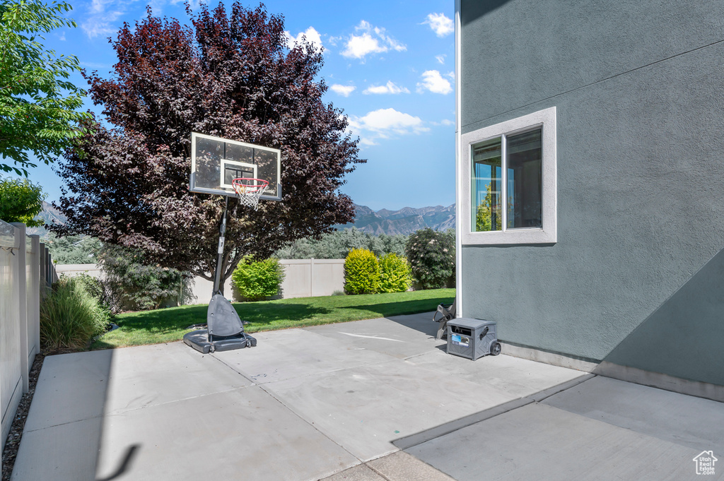 Fenced backyard with a mountain view and a patio