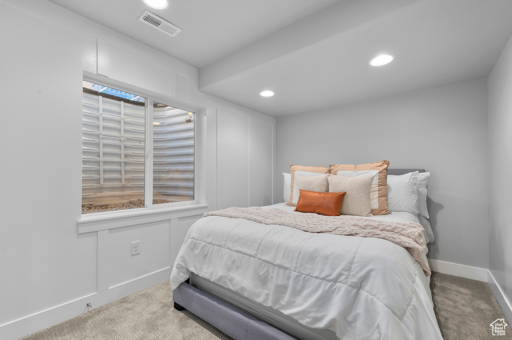Carpeted bedroom with baseboards and recessed lighting