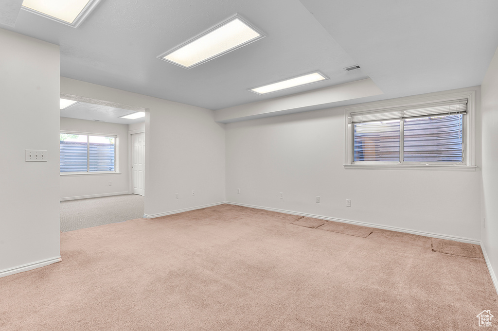 Spare room featuring carpet and baseboards