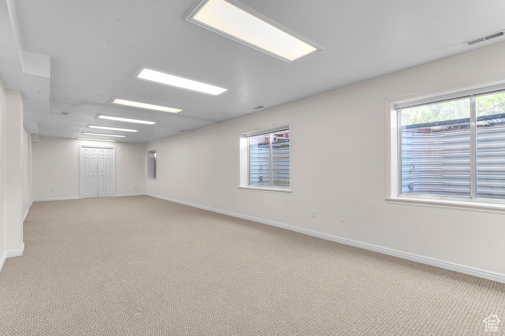 Spare room featuring light carpet
