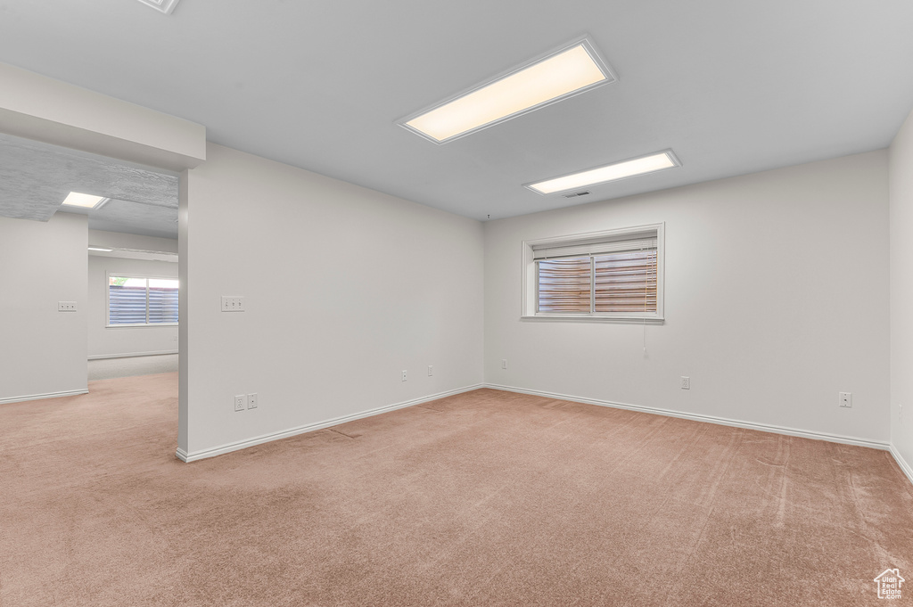 Empty room with light colored carpet