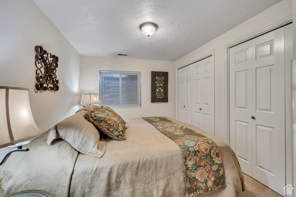 Carpeted bedroom with a textured ceiling