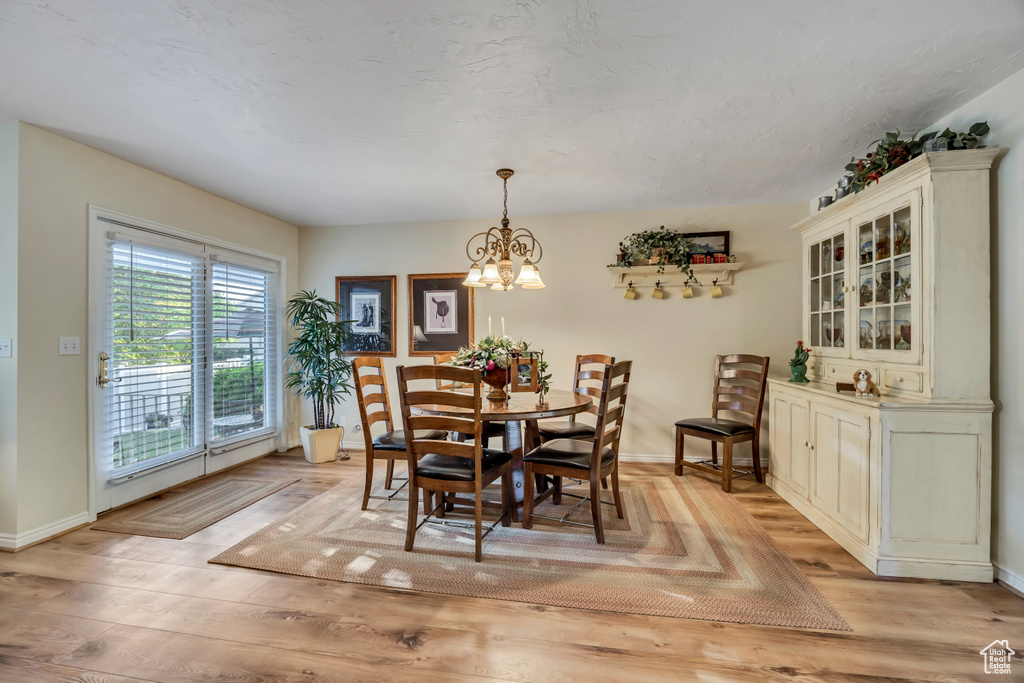 Dining area featuring a chandelier and light wood finished floors