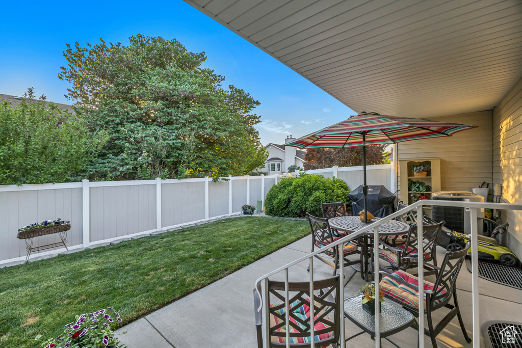 Fenced backyard with grilling area, a patio area, and outdoor dining area