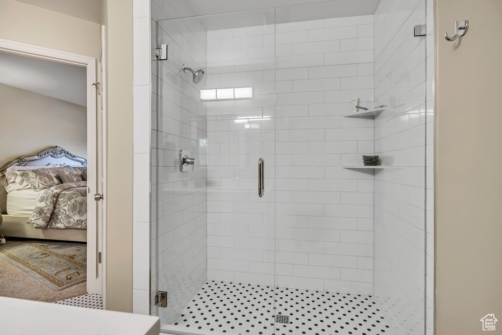 Ensuite bathroom featuring a stall shower