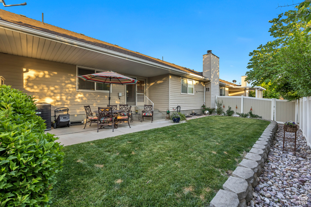 Rear view of property with a patio area and a chimney