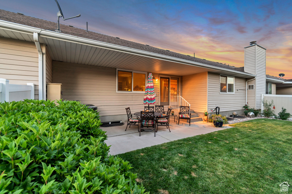 Rear view of property featuring a patio area and a chimney