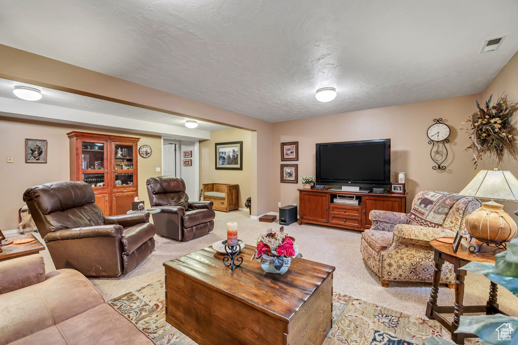 Living area with light carpet and baseboards