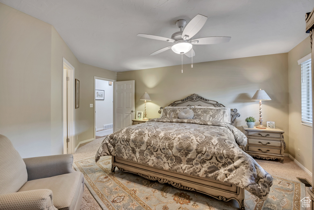 Carpeted bedroom featuring baseboards and ceiling fan