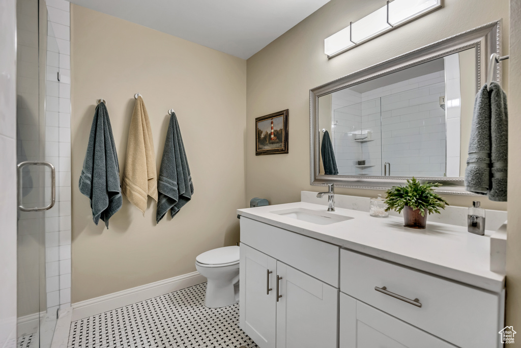 Bathroom with vanity, a stall shower, and tile patterned floors