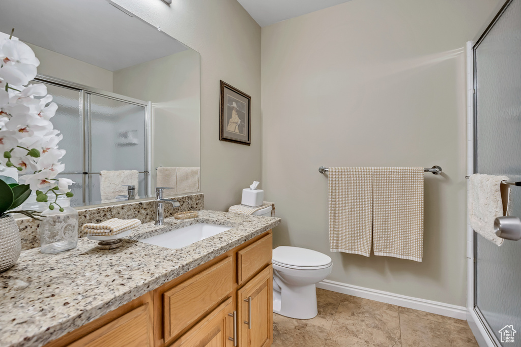 Full bathroom featuring a shower stall and vanity