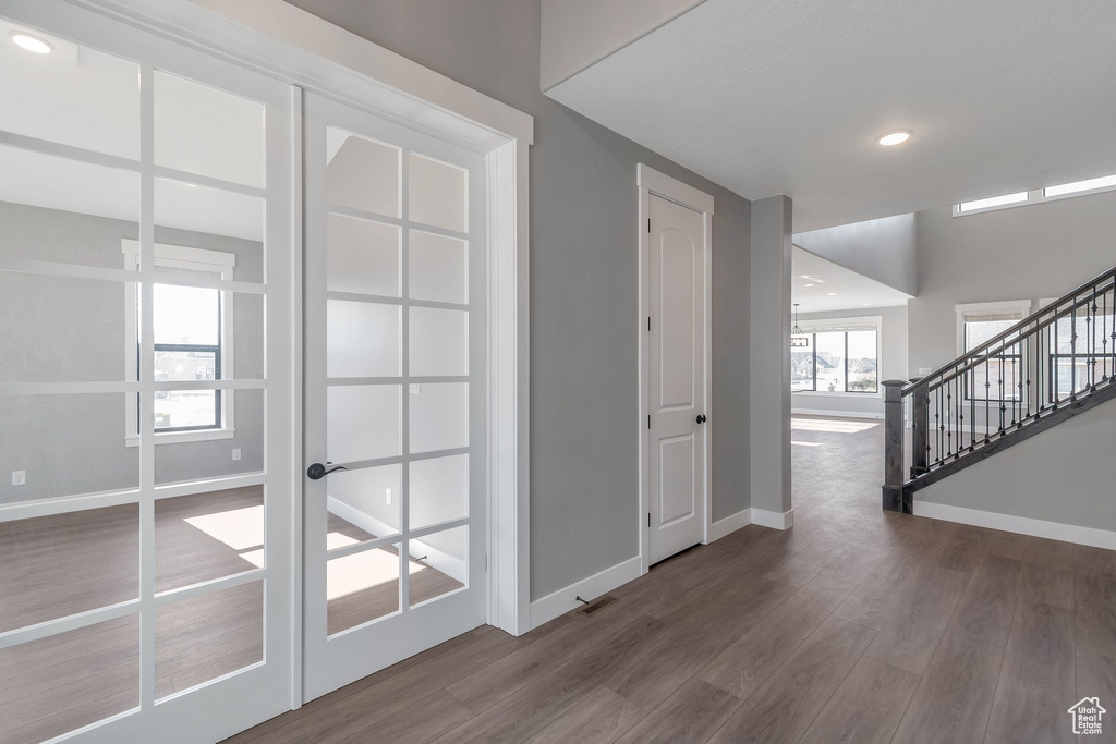 Foyer featuring wood finished floors, stairs, and recessed lighting