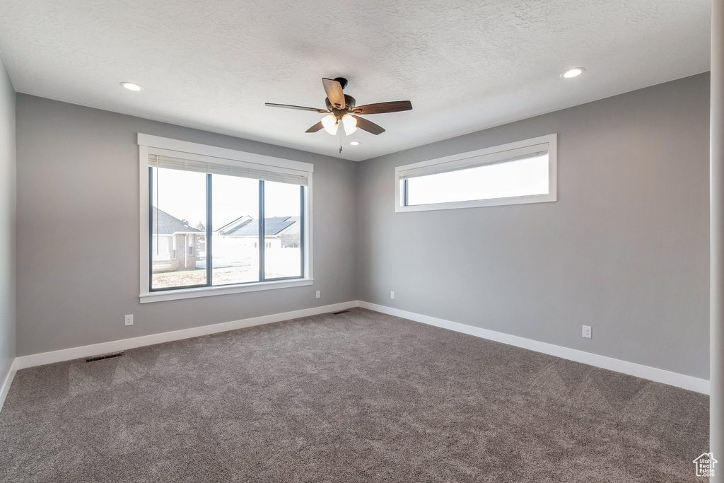 Unfurnished room with ceiling fan, carpet floors, recessed lighting, and a textured ceiling