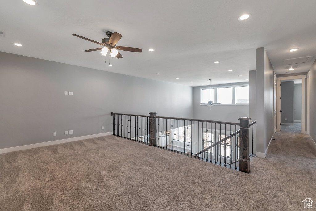 Spare room featuring carpet floors, ceiling fan, and recessed lighting