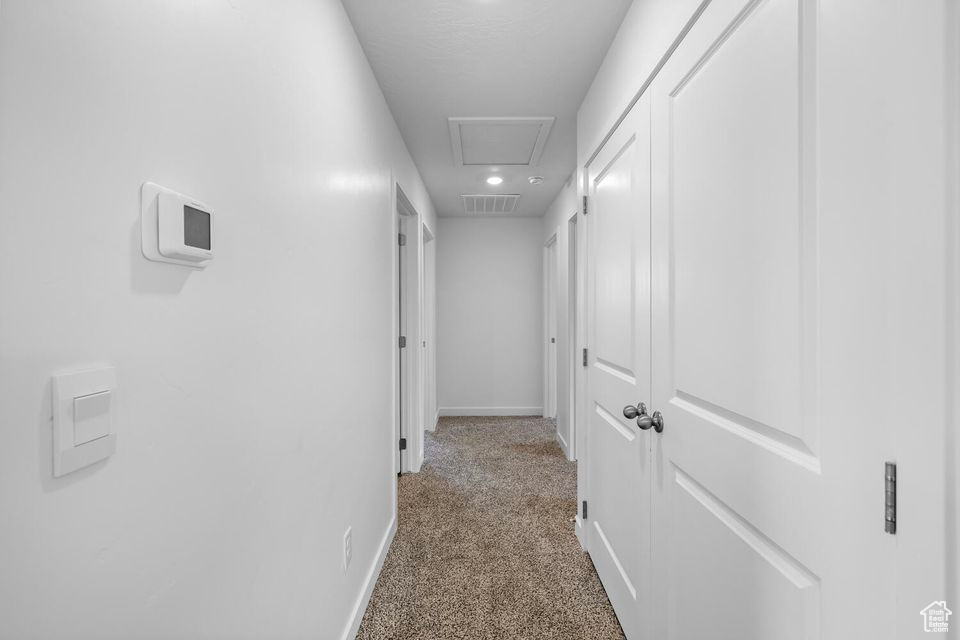 Hallway featuring baseboards and carpet flooring