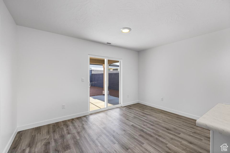 Spare room with wood finished floors and baseboards