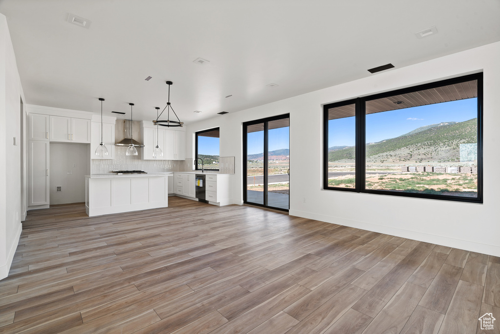 Unfurnished living room with light wood-style flooring