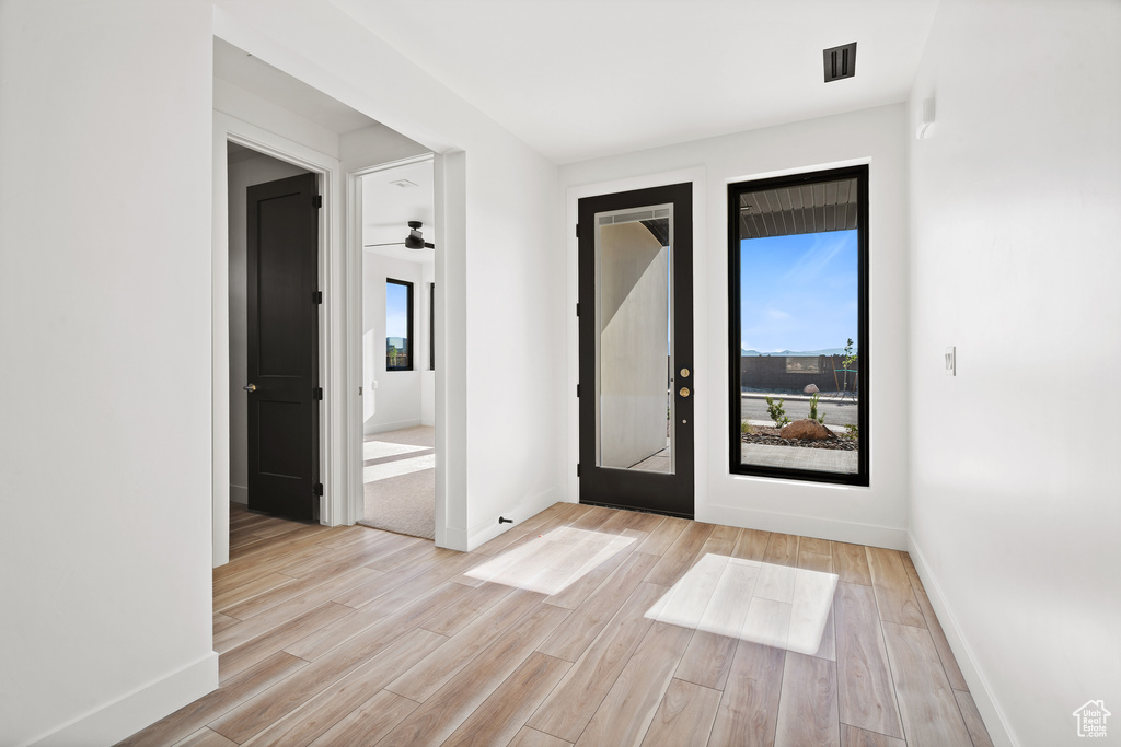 Entrance foyer with light wood-type flooring
